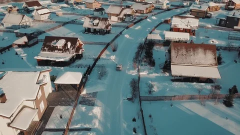 Rising up over typical winter suburb surrounded by white clear snow at sunset 動画素材 103551838