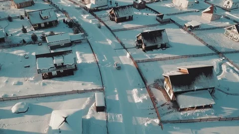 Rising up over typical winter suburb surrounded by white clear snow at sunset Vídeos de archivo 103551844