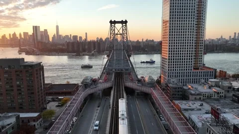 Rising pull back over Williamsburg Bridge roadway at sunset Stock Footage 344592193