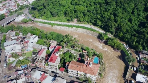 Rising River Passing through a Mexican City, Effects of Global Warming Stock Footage 253030777