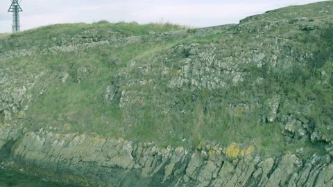 Rising Shot Cliffs and Medieval Monastery Ruins on Holy Island Aerial Drone Shot Stock Footage 197321511