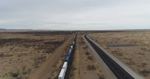 Rising up shot as freight train passes below drone aerial 4K Stock Footage 111315189