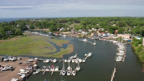 Rising shot over a river near a marina and marsh - gentle rise aerial drone shot Stock Footage 161031953