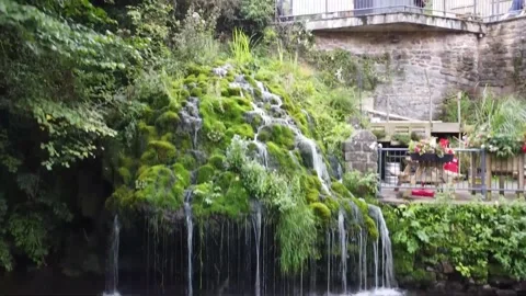 Rising shot of waterfall, set beside cottages,4K" Drone Stock Footage 212161340