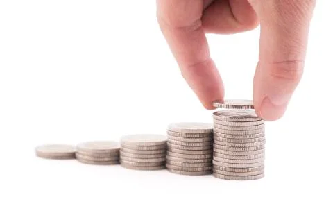 Rising stack of coins isolated on white background with clipping path Stock-Fotos