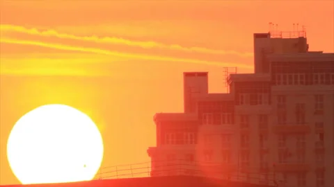 Rising sun appearing from the building Stock Footage 150486932