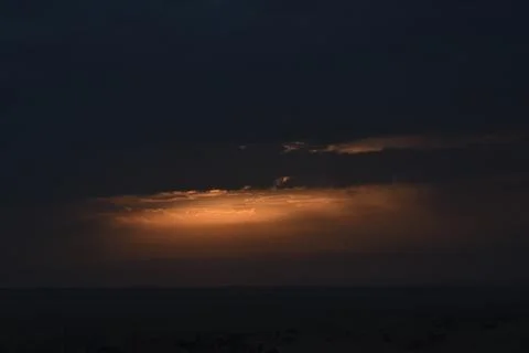 The rising sun is hidden by clouds. Stock Photos