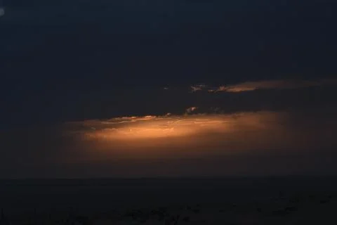 The rising sun is hidden by clouds. Stock Photos