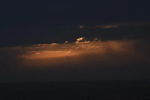 The rising sun is hidden by clouds. Stock Photos