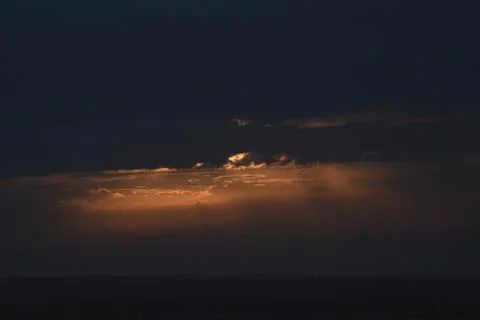 The rising sun is hidden by clouds. Stock Photos