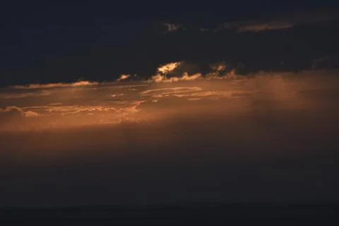 The rising sun is hidden by clouds. Stock Photos