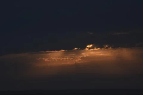 The rising sun is hidden by clouds. Stock Photos
