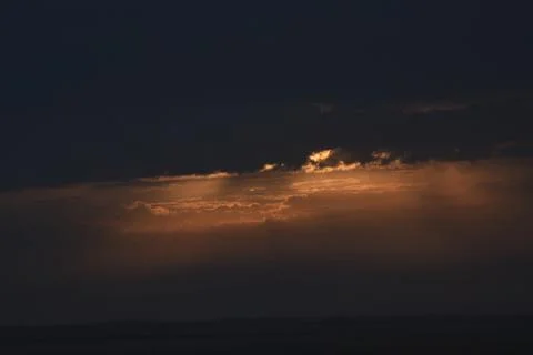 The rising sun is hidden by clouds. Stock Photos
