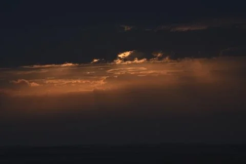 The rising sun is hidden by clouds. Stock Photos