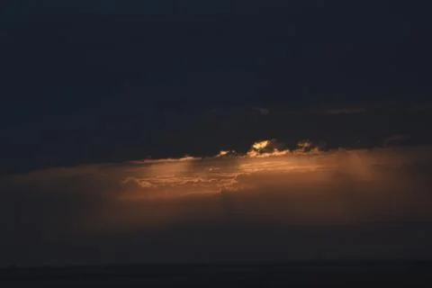 The rising sun is hidden by clouds. Stock Photos