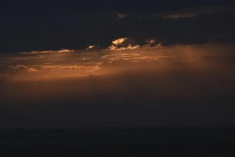 The rising sun is hidden by clouds. Stock Photos