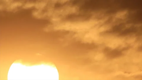 Rising sun move through dark clouds to cloudless sky Stock Footage 155448335