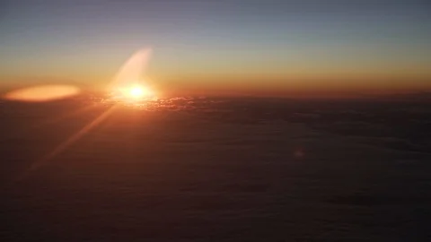 Rising sun over clouds. View from a airplane Stock Footage 127432072