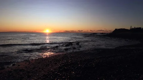 Rising sun over Pacific ocean horizon off Pebbly beach in Forster in AU as 4k. Stock Footage 197114352