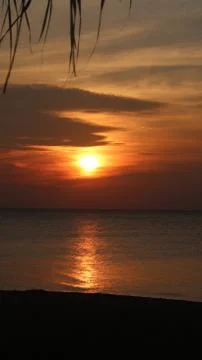 Rising Sun with reflection of rays on the ocean. Stock Photos