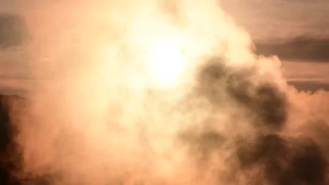 Rising sun smoke moving in front of the sunlight Stock Footage 254876131