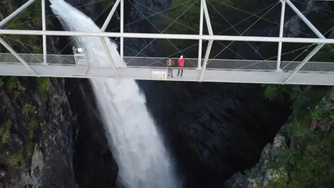 Rising Tilt Down Over Tourists on Gorsabrua Bridge Portraying Adventure Tourism Video stock 344997058