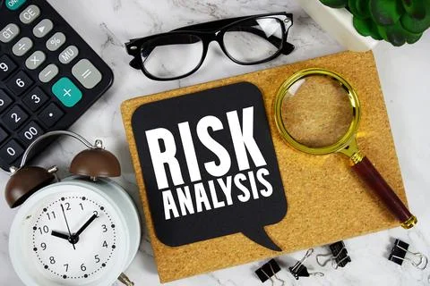 Risk Analysis text with Calculator, alarm clock and magnifying glass on mar.. Stock Photos