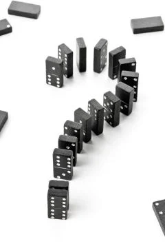 Risk, challenge or uncertainty concept - domino game stones forming questio.. Stock Photos