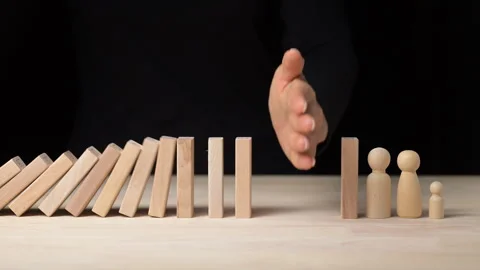 Risk Management Hand Stopping Falling Dominos in a Business Crisis - Decision Stock Footage 296262398
