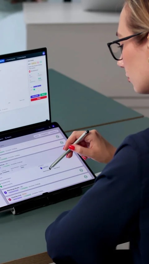 Risk Manager Analyzes Compliance Data On Dual-screen Laptop Stock Footage 340403043