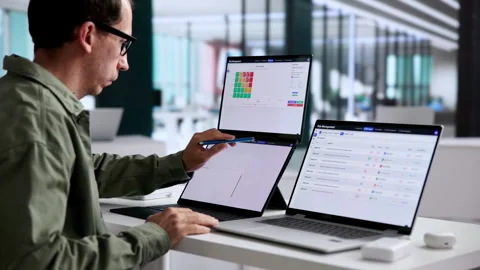 Risk Manager Analyzes Dual Touchscreen Laptop Stock Footage 347909254