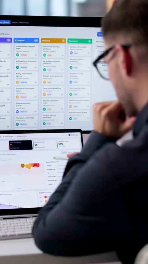 Risk Manager Analyzing Compliance Data On Dual Screen Laptop Stock Footage 342964588