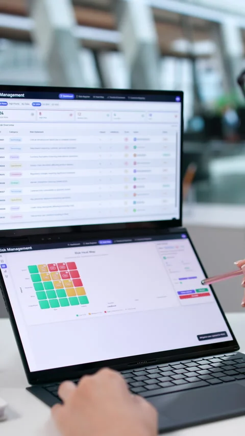 Risk Manager Carefully Analyzing Data On Dual Touchscreen Laptop Stock Footage 344715678