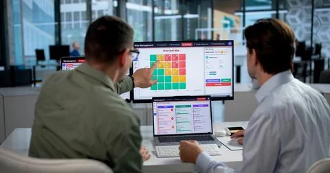Risk Manager Carefully Analyzing Financial Data On Laptop For Strategic Plann Stock Photos