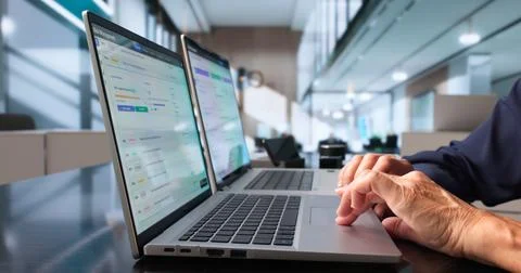 Risk Manager Reviews Security Data On Laptop To Assess Business Risks. Stock Photos