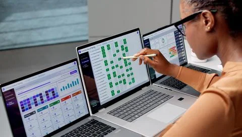Risk Manager Studies Compliance Dashboard On Laptop For Better Governance. Stock Photos