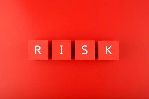 Risk single word written on red cubes against red background Stock Photos