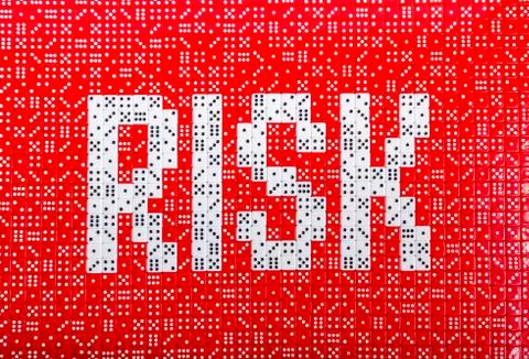 RISK spelled with dice 3 Stock Photos