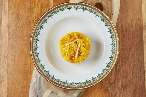 Risotto, ready-made portion of step-by-step recipe in a vintage plate on a wo Stock Photos