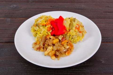 Risotto with vegetables and nuts on a table Stock Photos