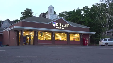 Rite Aid Pharmacy with last minute shopper pulling up in Everett PA 4k Stock Footage 245672109