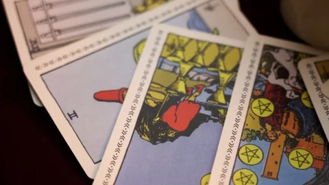 A rite for summoning spirits using ancient tarot cards around candles on table. Stock Footage 108023394