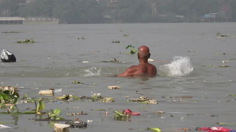Ritual bathing in polluted Hooghly river in Kolkata, religion in India Stock Footage 48785166