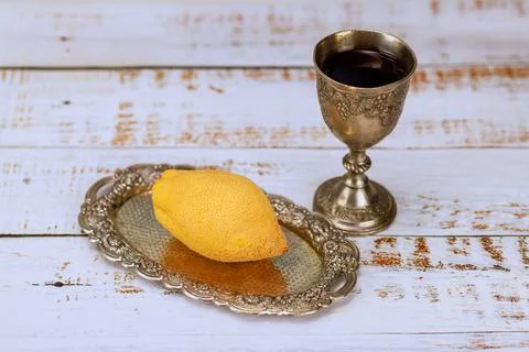 Ritual objects for Sukkot celebration. Etrog fruit on silver plate with kiddush Stock Photos