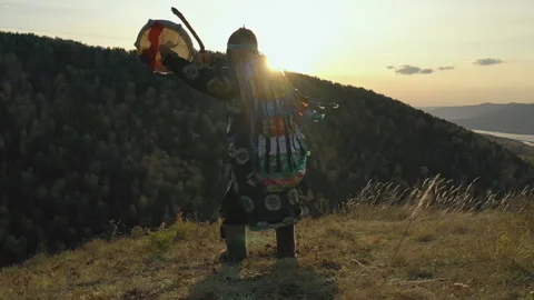 Ritual traditional dance with tambourine Siberian shaman at sunset. Stock Footage