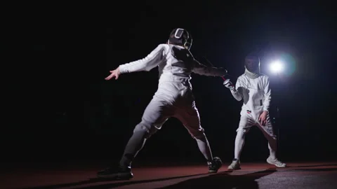 Rivals Fencers Fighting With Epees In Darkness, Fencing Track For Match And Video stock 279896355