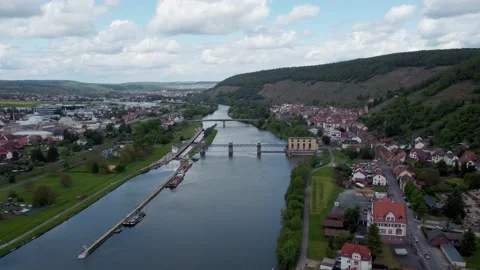 A river with 2 bridges next to a town Stock Footage 154553400