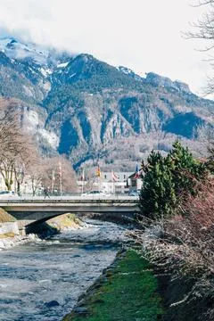 River and bridge against the backdrop of a towering mountain Stock Photos