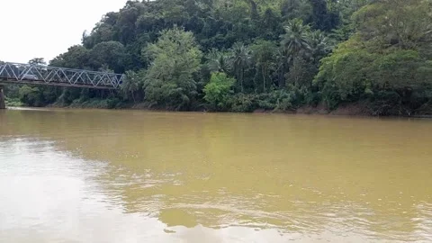 River and bridge between vehicles passing over it Stock Footage 296304187