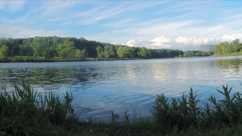 River and clouds over the park timelapse Stockbeeldmateriaal 77285021
